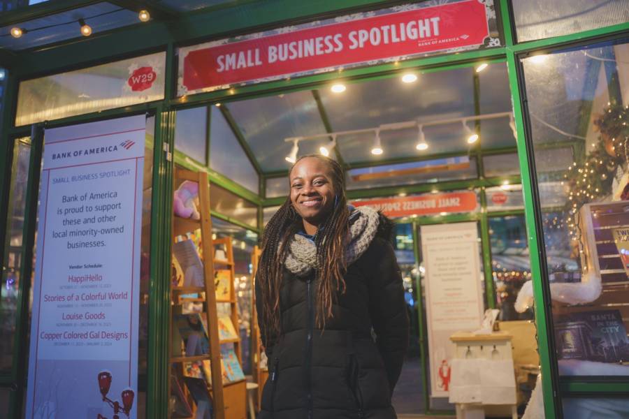 A small business owner stands in front of her store at the Small Business Spotlight at Bank of America Winter Village at Bryant Park in New York City.